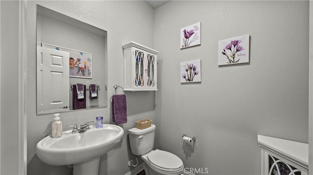 bathroom featuring sink and toilet