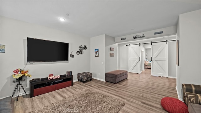 living room with hardwood / wood-style floors and a barn door