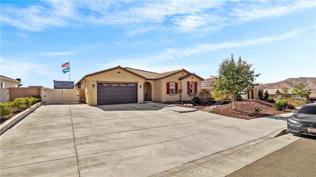 view of front of home with a garage and a mountain view