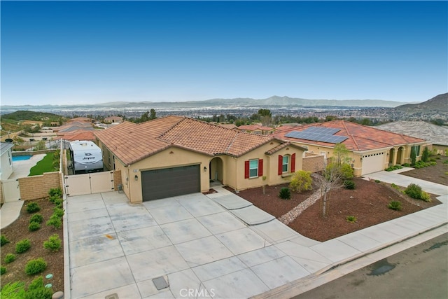 mediterranean / spanish home featuring a mountain view and a garage