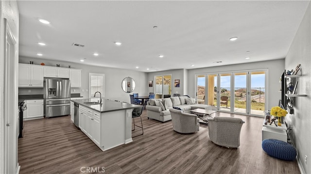 living room featuring sink and dark wood-type flooring