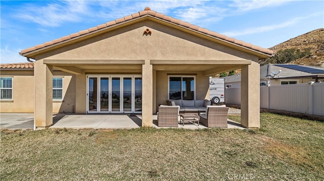 back of property with a patio area and a yard