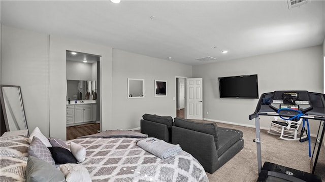 bedroom featuring connected bathroom and carpet flooring