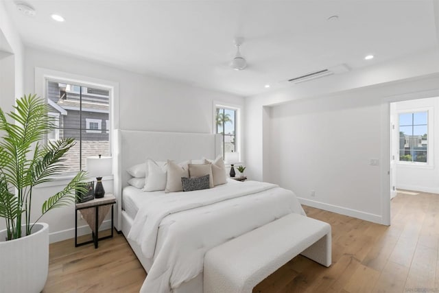 bedroom with light hardwood / wood-style floors and ceiling fan