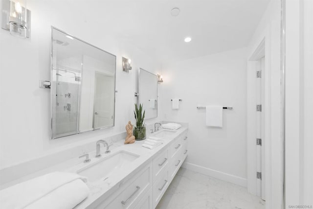 bathroom with a shower with door and vanity