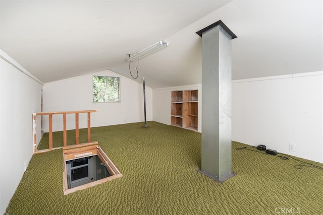 bonus room featuring built in shelves, vaulted ceiling, and carpet flooring