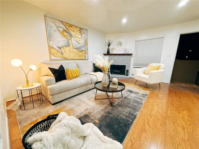 living room with hardwood / wood-style flooring and a fireplace