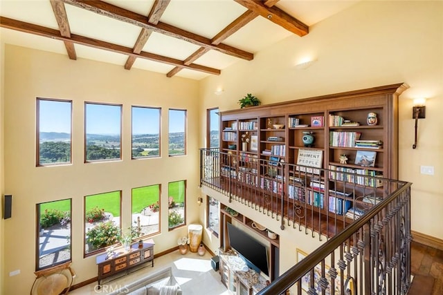 living area with beamed ceiling and coffered ceiling