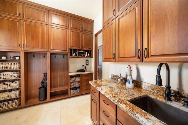 kitchen with light stone countertops and sink