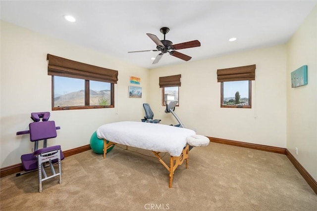 bedroom with ceiling fan and light carpet