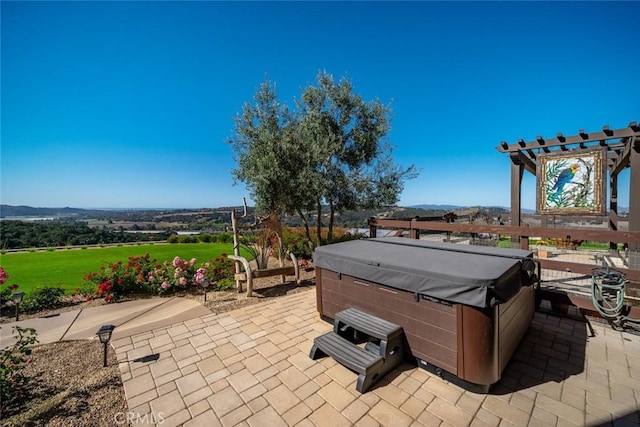 view of patio with a hot tub and a pergola