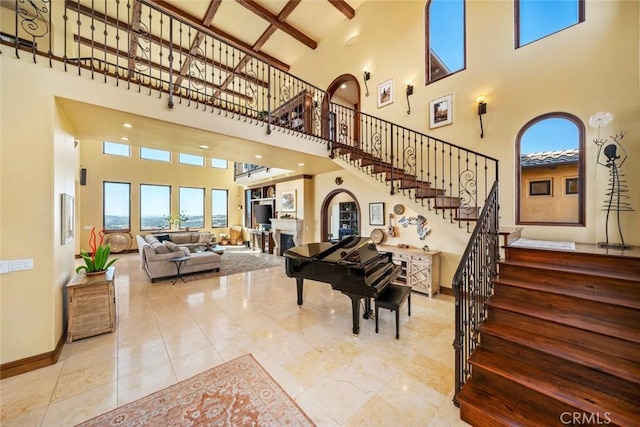 interior space featuring beamed ceiling and a high ceiling