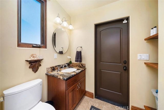 bathroom featuring toilet, tile patterned floors, and vanity