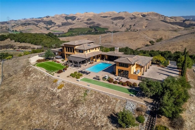 birds eye view of property with a mountain view