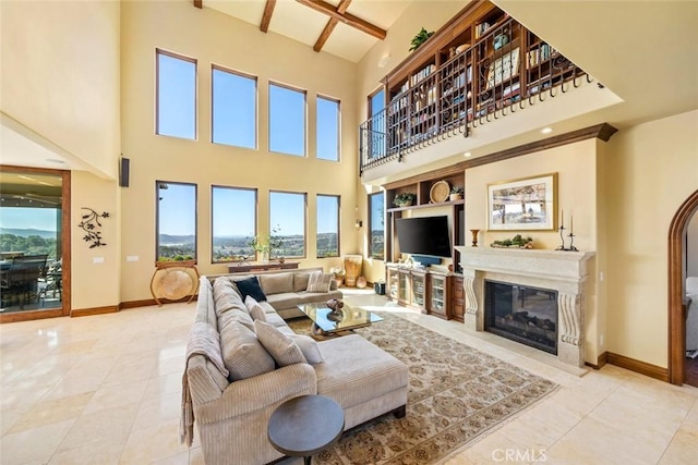 living room with a high ceiling, built in features, beam ceiling, and coffered ceiling