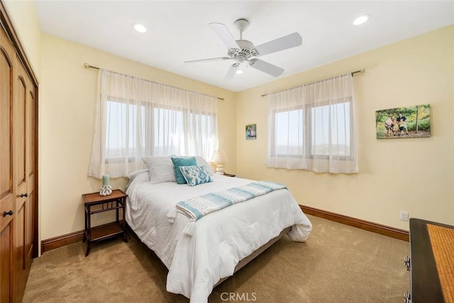 carpeted bedroom featuring a closet and ceiling fan