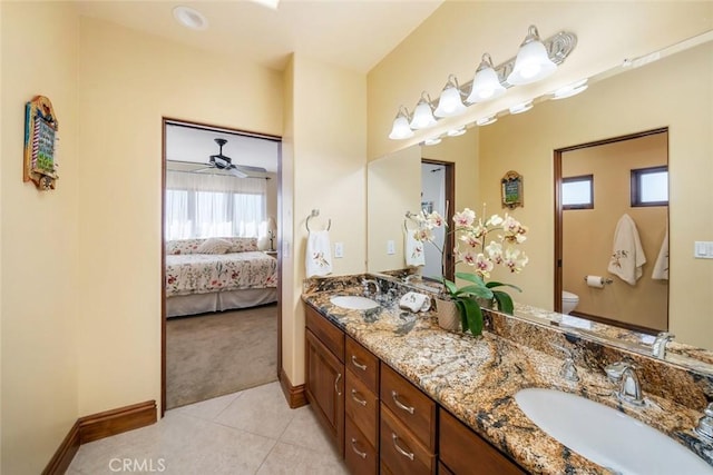 bathroom featuring ceiling fan, vanity, tile patterned flooring, and toilet