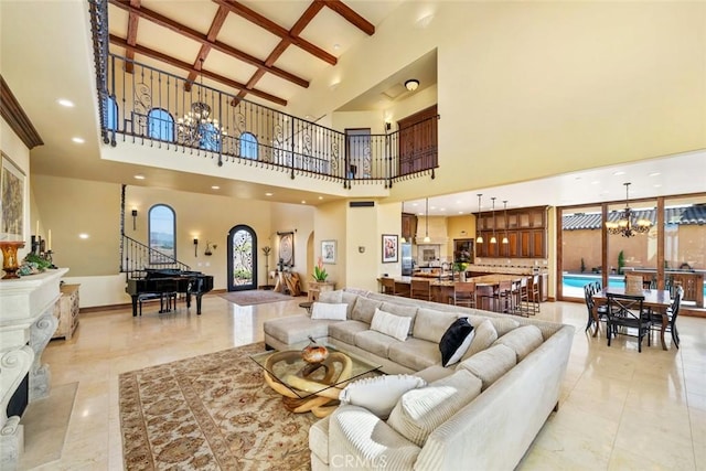 living room with a notable chandelier, a towering ceiling, coffered ceiling, and beamed ceiling