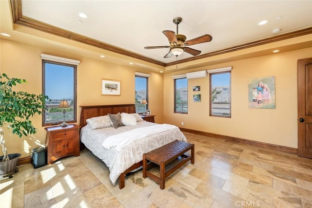 bedroom featuring ceiling fan, a tray ceiling, and ornamental molding