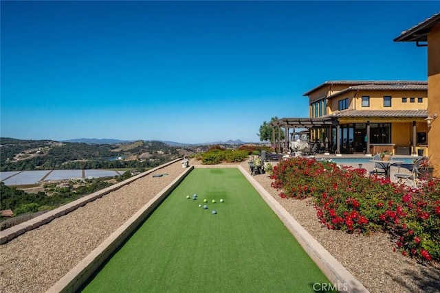 view of home's community featuring a mountain view and a pool