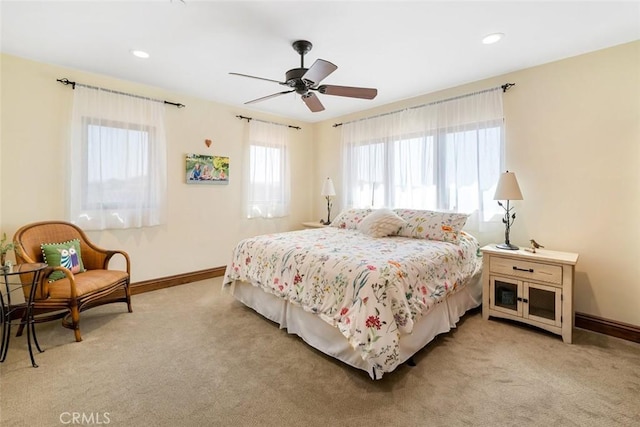 bedroom with ceiling fan and light carpet