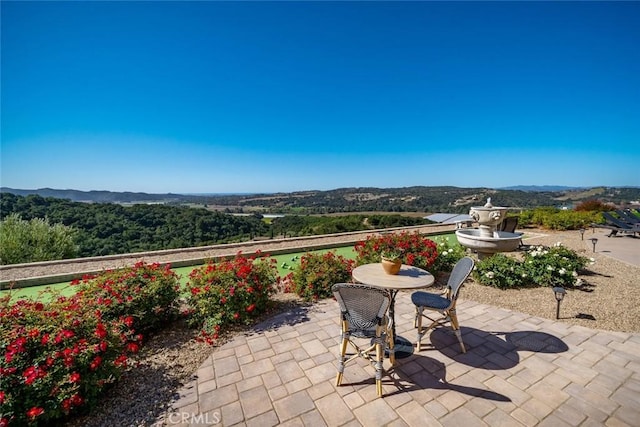 view of patio / terrace featuring a mountain view