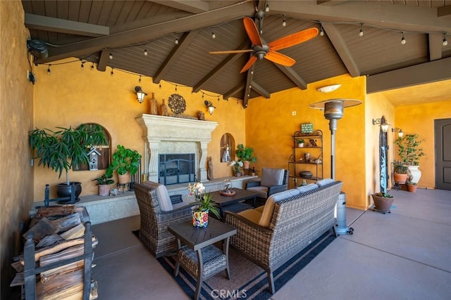 view of patio featuring ceiling fan and an outdoor living space with a fireplace