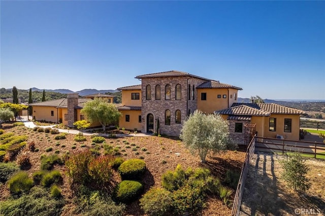 back of house with a mountain view