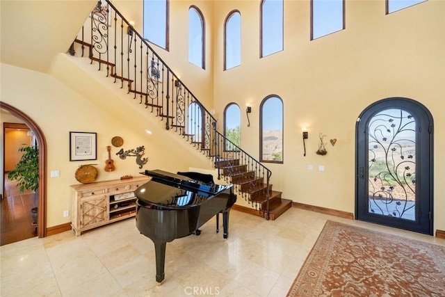 foyer entrance featuring a towering ceiling