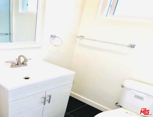 bathroom featuring tile patterned floors, vanity, and toilet