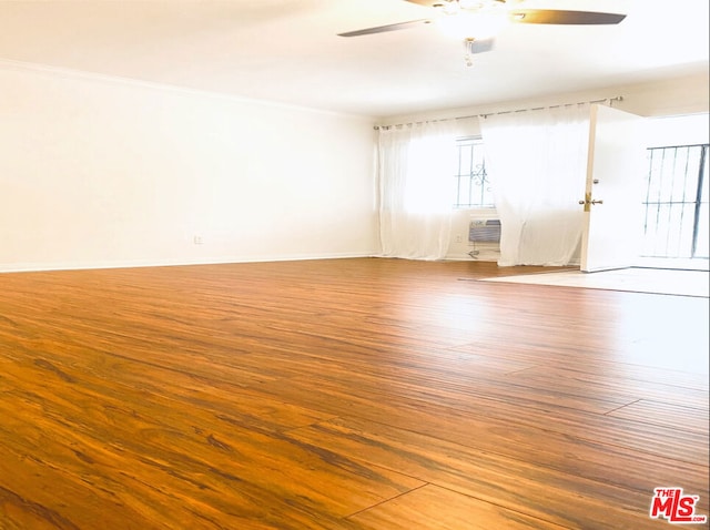 unfurnished room with hardwood / wood-style flooring, ceiling fan, and crown molding