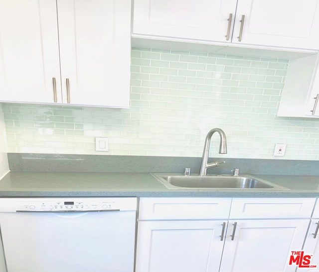 kitchen with dishwasher, white cabinets, tasteful backsplash, and sink