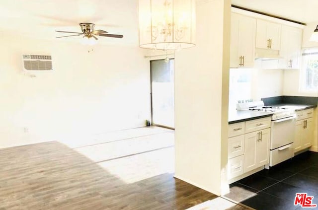 kitchen with white range oven, white cabinetry, ceiling fan, and dark hardwood / wood-style floors