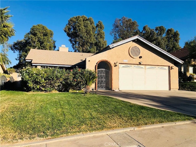 view of front of property featuring a garage and a front lawn