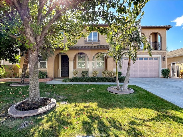 mediterranean / spanish house featuring a front lawn and a garage