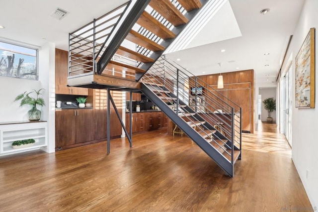 stairway with hardwood / wood-style floors