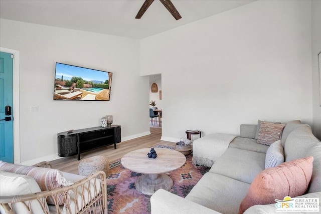 living room with light hardwood / wood-style floors and ceiling fan