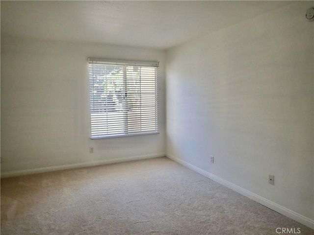 unfurnished room featuring light carpet