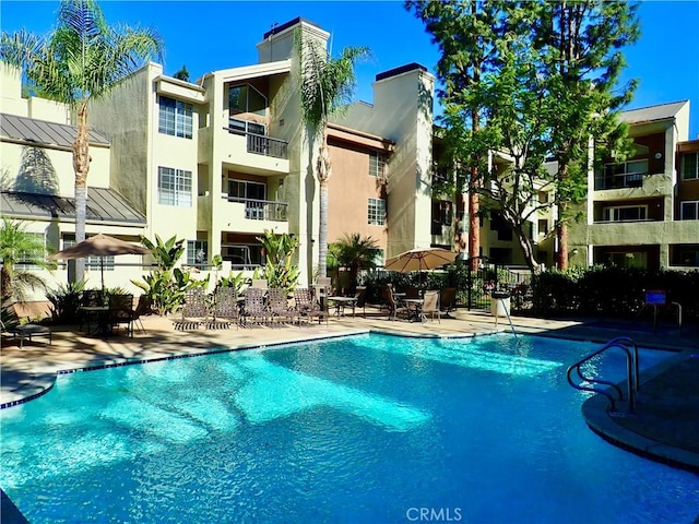 view of swimming pool featuring a patio area