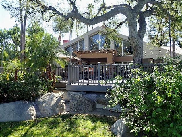 back of house featuring a wooden deck