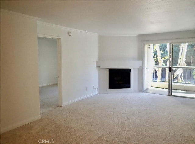 unfurnished living room featuring light carpet and ornamental molding