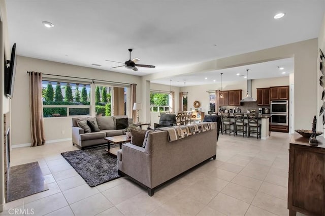 living room with ceiling fan and light tile patterned floors