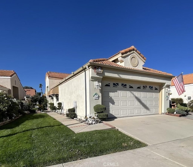 view of side of home with a lawn and a garage