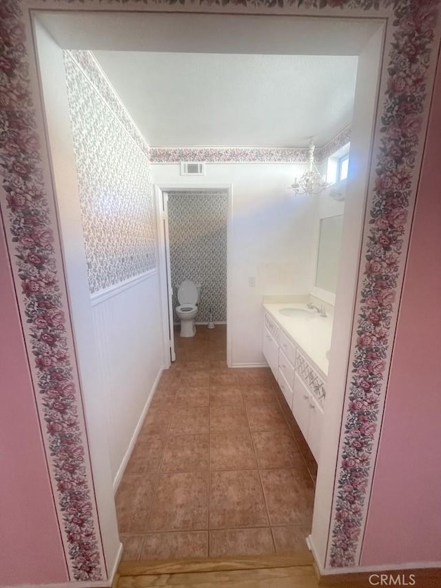 bathroom with tile patterned floors, vanity, and toilet