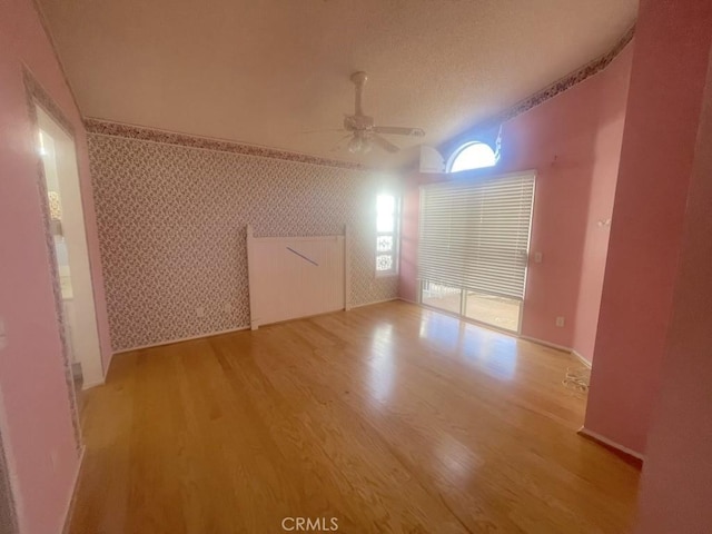 bonus room with light wood-type flooring and ceiling fan