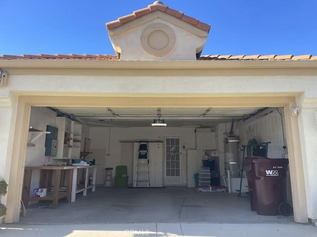 garage featuring secured water heater and a garage door opener