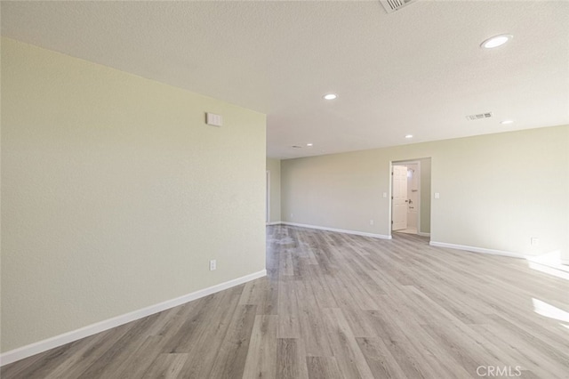 spare room with light wood-type flooring