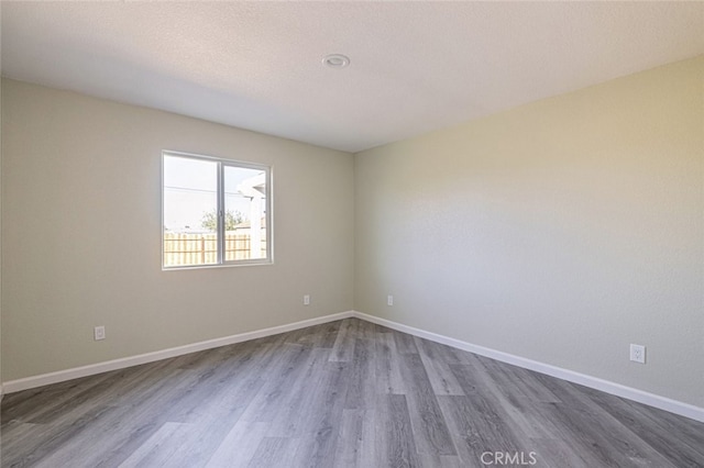 unfurnished room featuring hardwood / wood-style floors