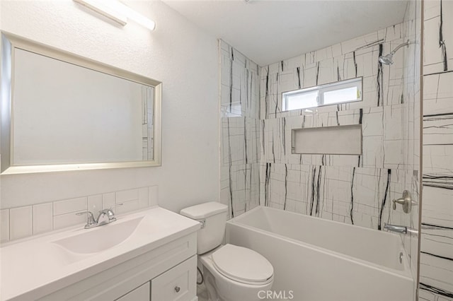 full bathroom featuring vanity, toilet, tiled shower / bath, and tasteful backsplash