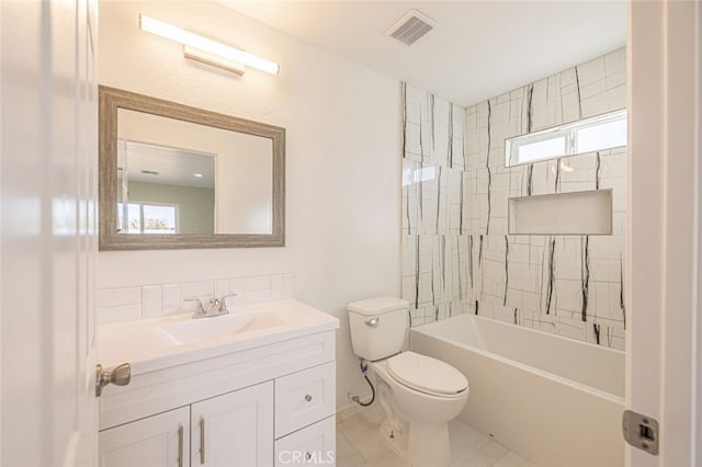 full bathroom featuring tile patterned floors, vanity, toilet, and tiled shower / bath combo